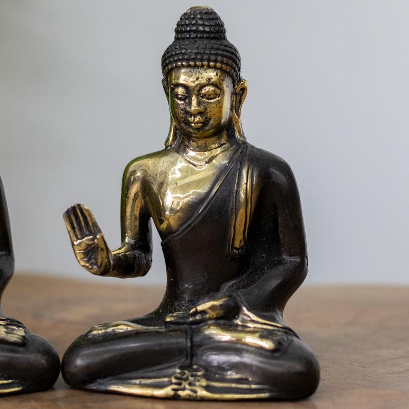 Objeto decorativo em bronze maciço com brilho metálico dourado, representando a serenidade e a sabedoria do mestre Buda.
