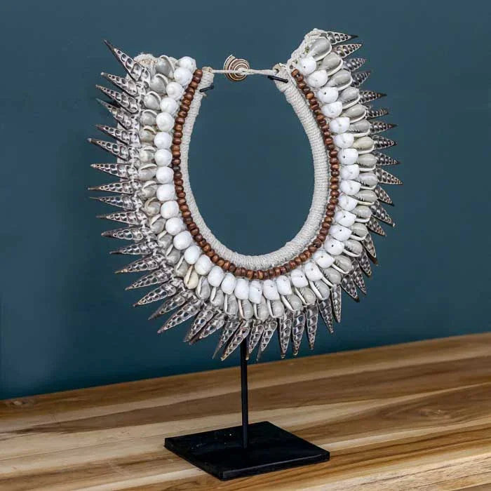 Objeto decorativo étnico com colar tribal em conchas da cultura Papua.