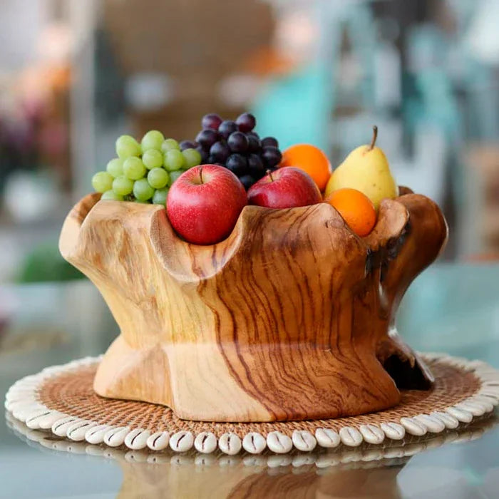 Peça escultural feita em madeira teca balinesa, com veios mesclados e formas sinuosas, utilizada como centro de mesa ou fruteira decorativa.