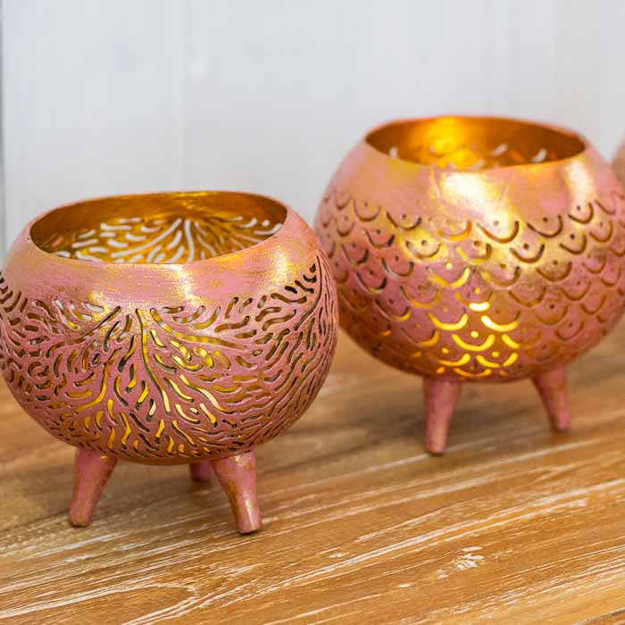 Porta-vela de coco natural sobre superfície rústica evidenciando o trabalho manual.