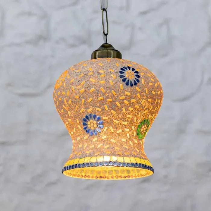 Detalhe da cúpula de sino em vidro com padrão de mosaico e acabamento metálico envelhecido.