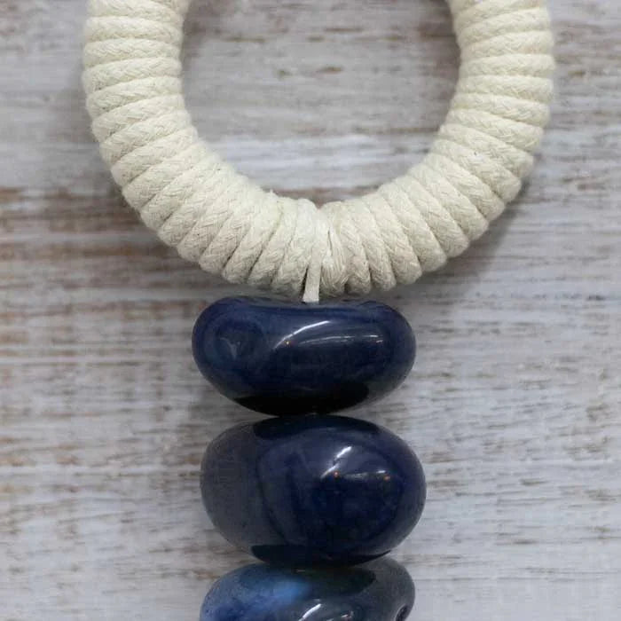 Protetor espiritual brasileiro com amuletos tradicionais e acabamento natural.