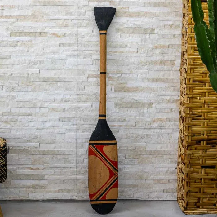 Remo indígena esculpido manualmente com traços gráficos que remetem às tradições visuais dos povos do Xingu