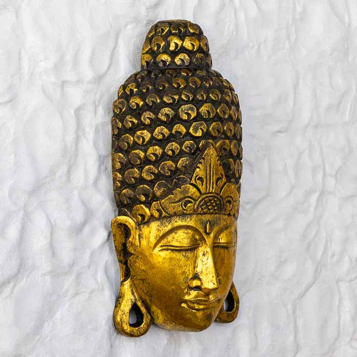 Escultura decorativa Buda Face com acabamento dourado e expressão serena.