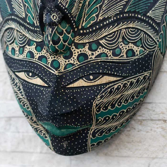 Objeto simbólico esculpido em madeira com técnica Batik, refletindo a tradição artesanal da Indonésia