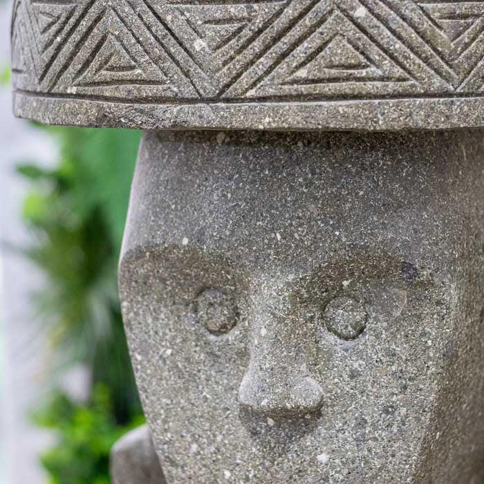 Estátua primitiva com aparência rústica e simbologia espiritual ancestral.