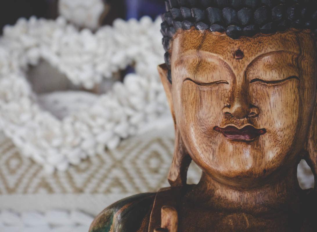 Uma escultura de Buda, irradiando serenidade e benevolência, trazendo uma energia positiva e tranquilizadora ao ambiente.
