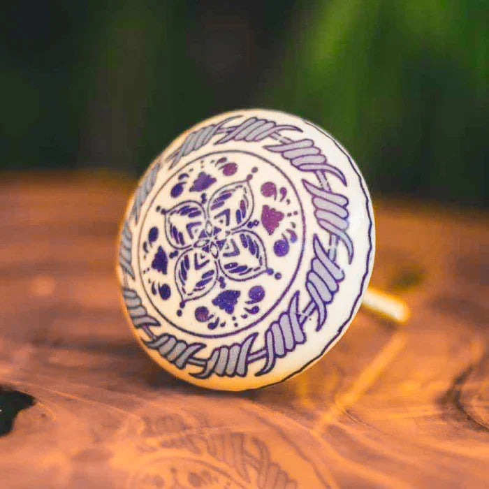 Detalhe de puxador em cerâmica com arabesco azul para móveis.