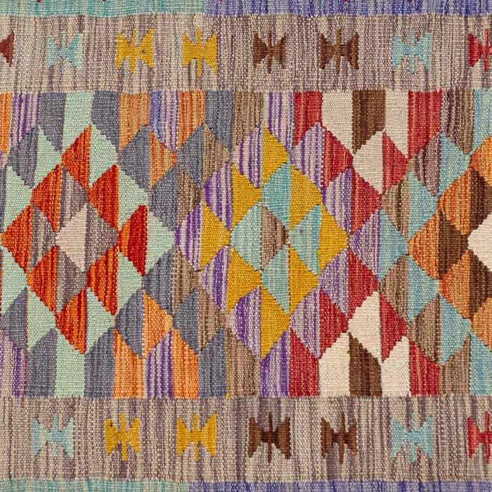 Passadeira artesanal Kilim do Afeganistão com grafismos étnicos multicoloridos e técnica de tecelagem plana manual.