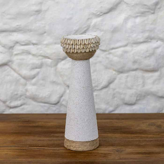 Castiçal decorativo balinês colunar com topo de búzios naturais e corpo de miçangas brancas em três tamanhos.