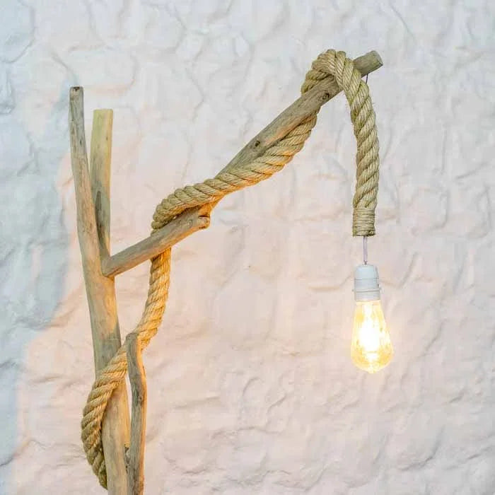 Abajur de chão rústico esculpido em madeira natural com corda de sisal trançada ao longo da estrutura. 