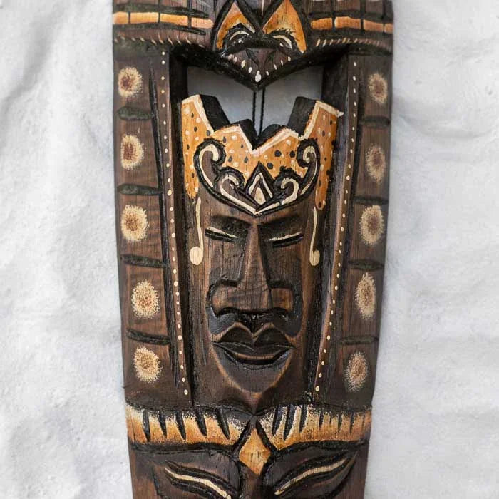 Máscara entalhada artesanal de Bali com duas expressões opostas.