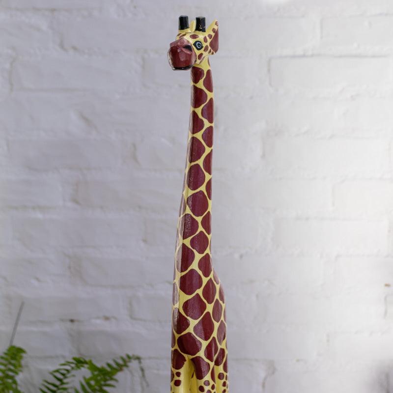 Escultura de girafa com base em madeira artesanal — decoração étnica.  