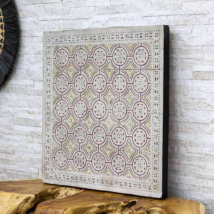 Painel quadrado de fibrocimento com padrões étnicos de Timor em tons de terracota e ocre.